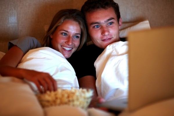 couple watching tv movie netflix bed