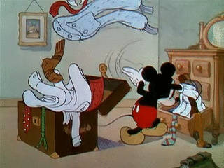 Mickey Mouse trying to pack a suitcase