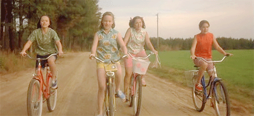 Girls from Now and Then riding bikes