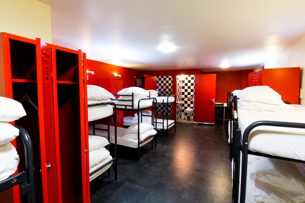 Black and white checkerboard and red coloured dorm room.