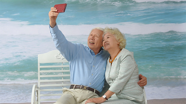 Elderly Grandparents on Beach Vacation Selfie