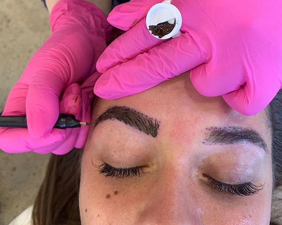Eyebrows being microbladed