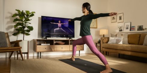 Woman following workout video in living room