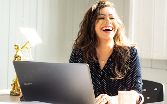 business woman laughing laptop