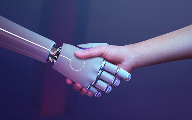 bionic hand representing artificial intelligence reaches out to shake a human hand