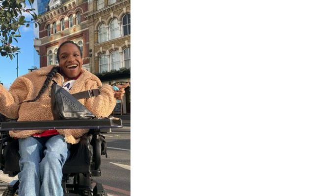 Aaron Rose Philip smiling in her wheelchair on a city street