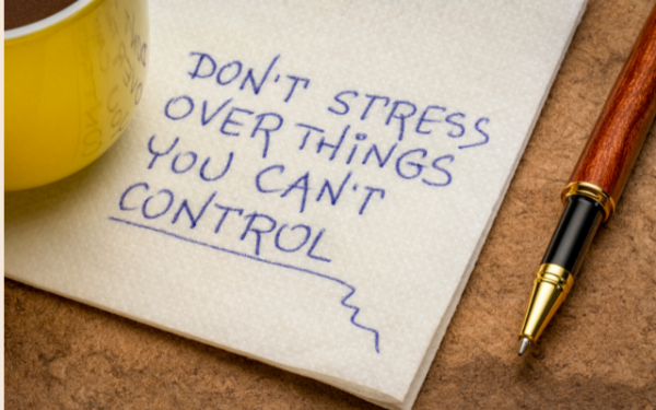 yellow mug on a napkin with a handwritten note saying don't stress over things you can't control